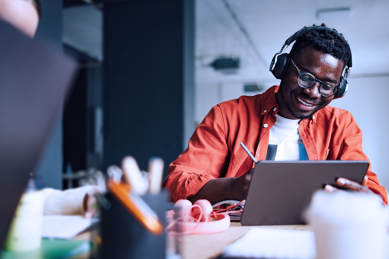viant-adelphic-dsp-certification-smiling black male student with headphones studying