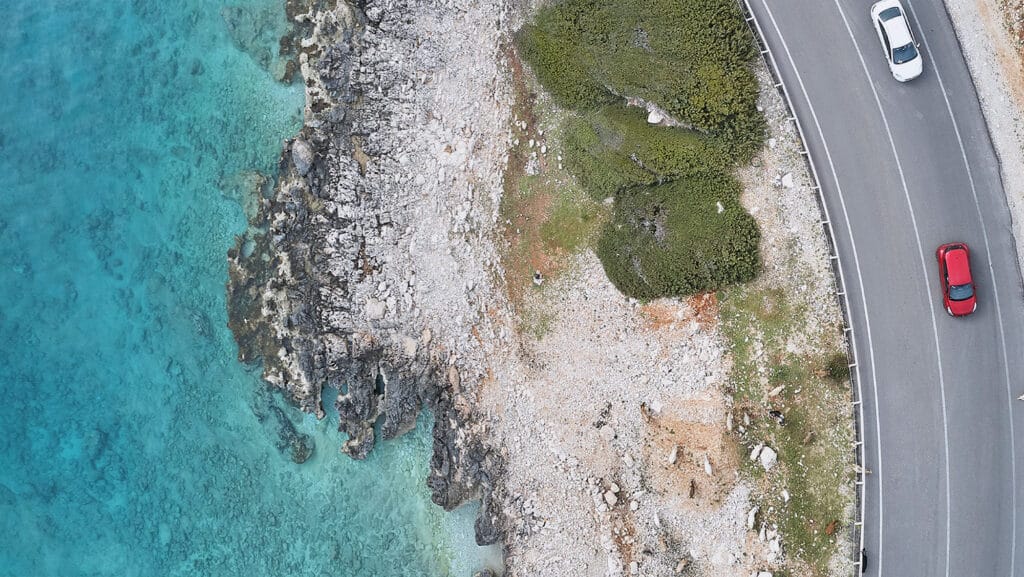 Image of cars driving on a coastal road