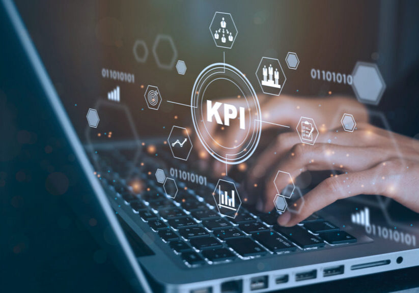 Person typing on laptop with KPI dashboard overlay representing CTV measurement metrics and campaign performance tracking.