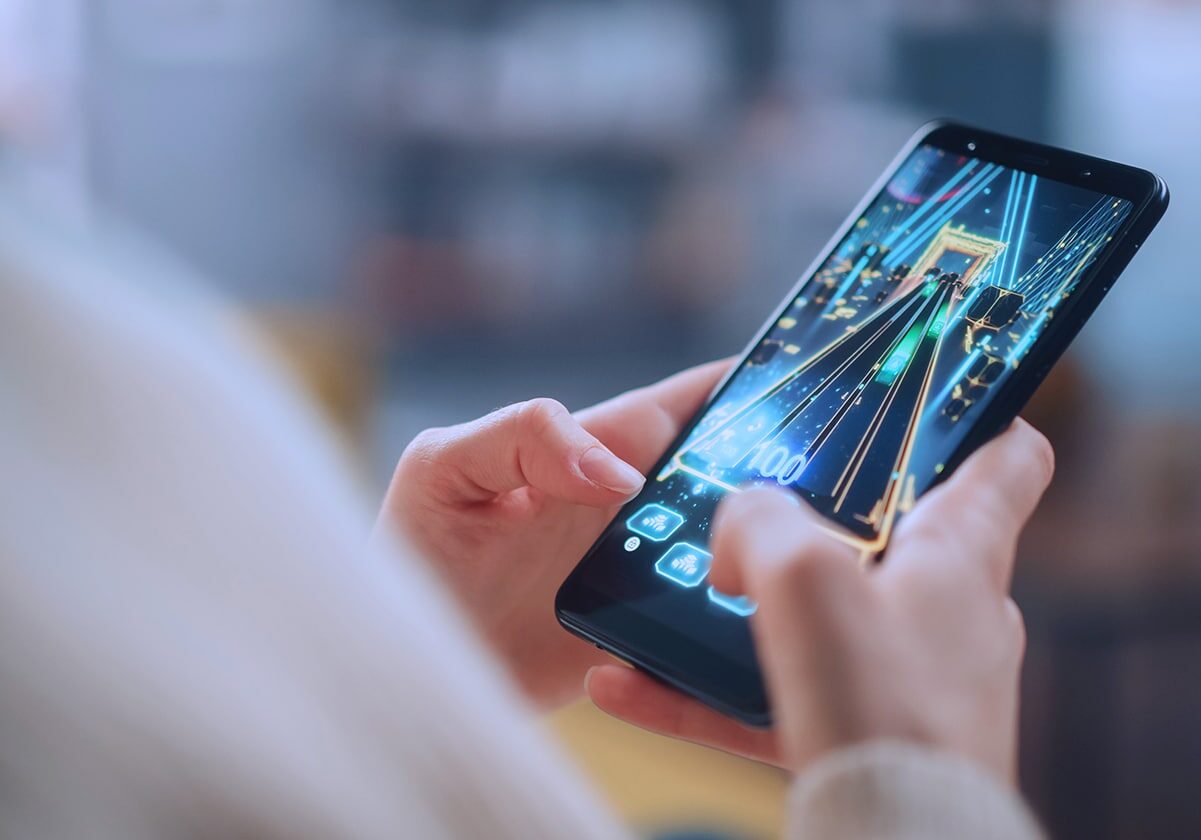 viant-industry-solutions-gaming-close up of person playing game on phone